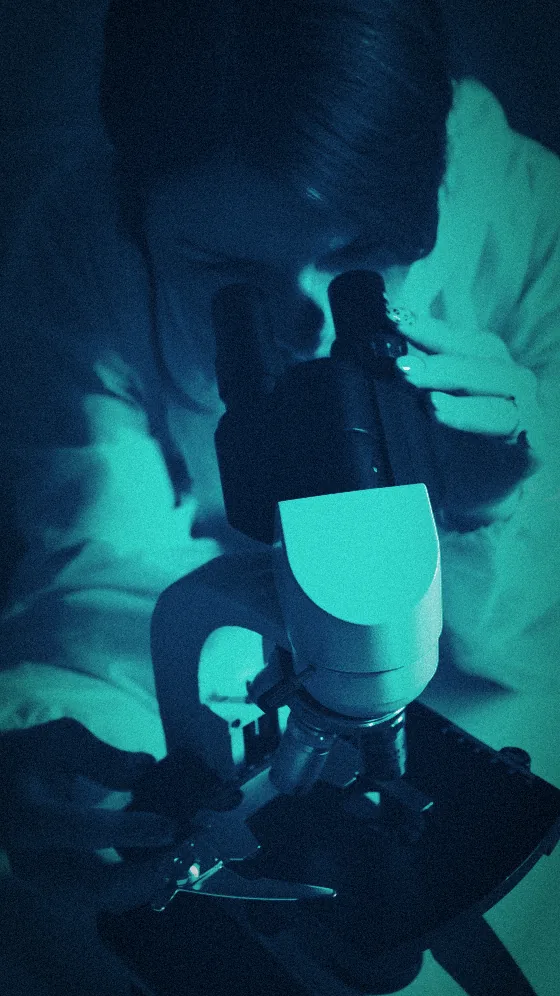 Researcher examining a sample under a microscope